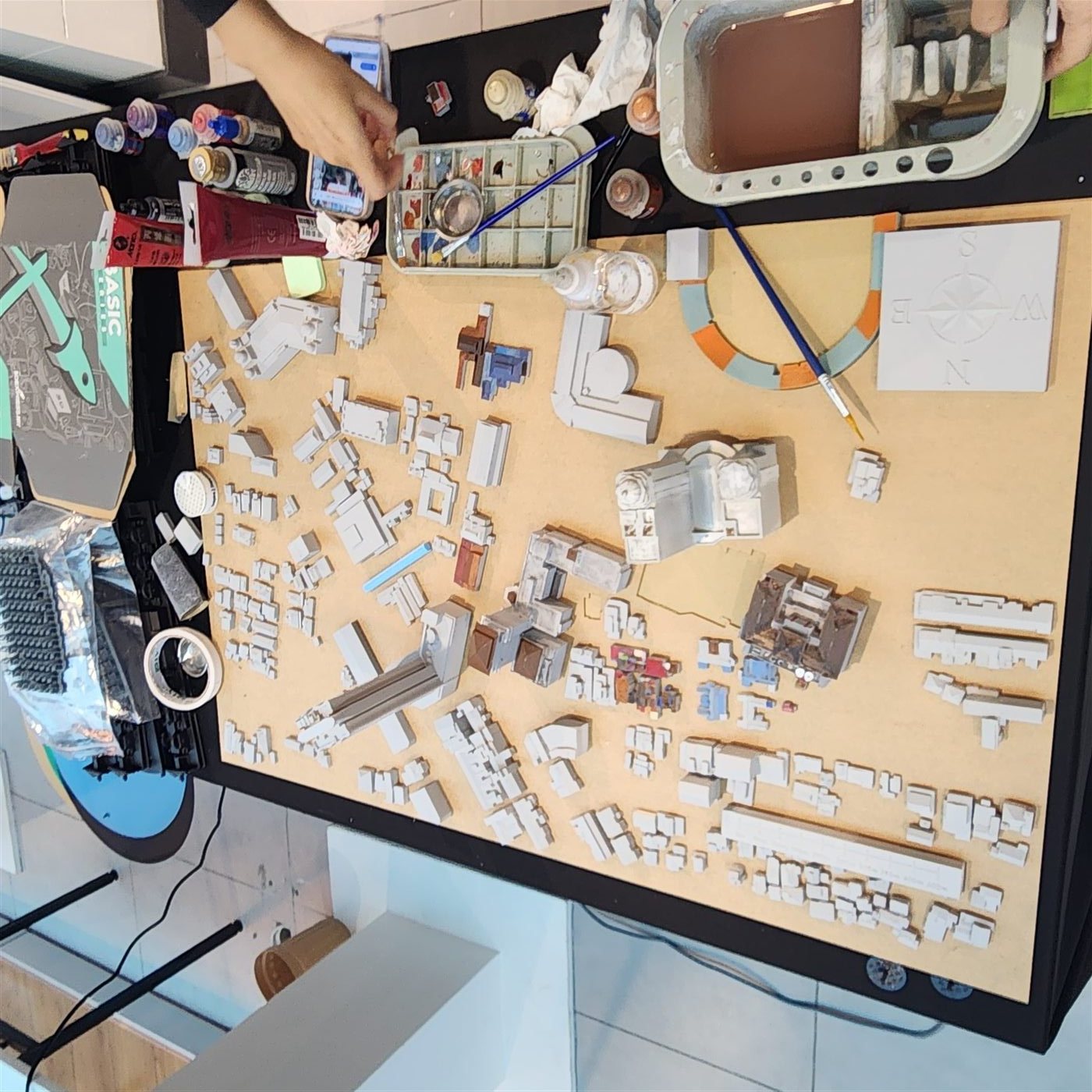 Hand-painting individual buildings of a city masterplan model at the 3D Forger atelier