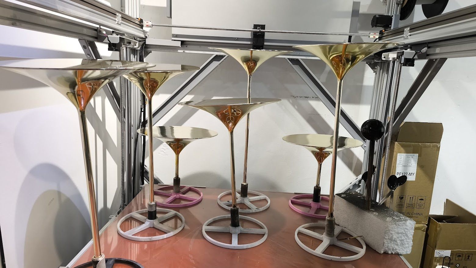 Gold finished trumpet pedestals for luxury retail display by 3D Forger